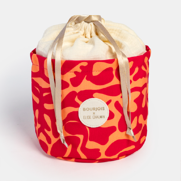 Le pochon en tissu réutilisable du calendrier Bourjois, avec son motif rouge et orange, fermé par son cordon de serrage.