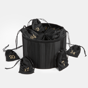 Black pleated advent calendar with numbered pockets, presented at LUXE PACK Monaco 2024 and featured in the press.